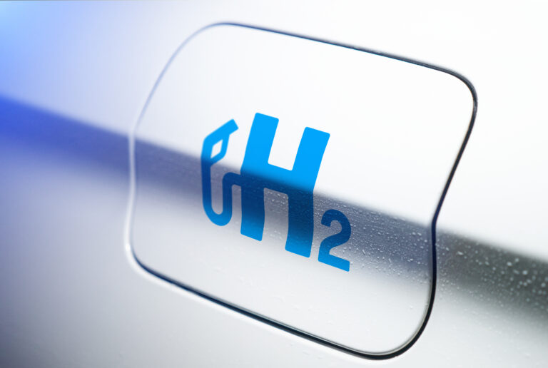 car with hydrogen logo on filler cap. h2 combustion engine for emission free ecofriendly transport.